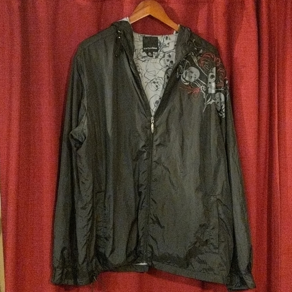 Black windbreaker with skull graphics. XL